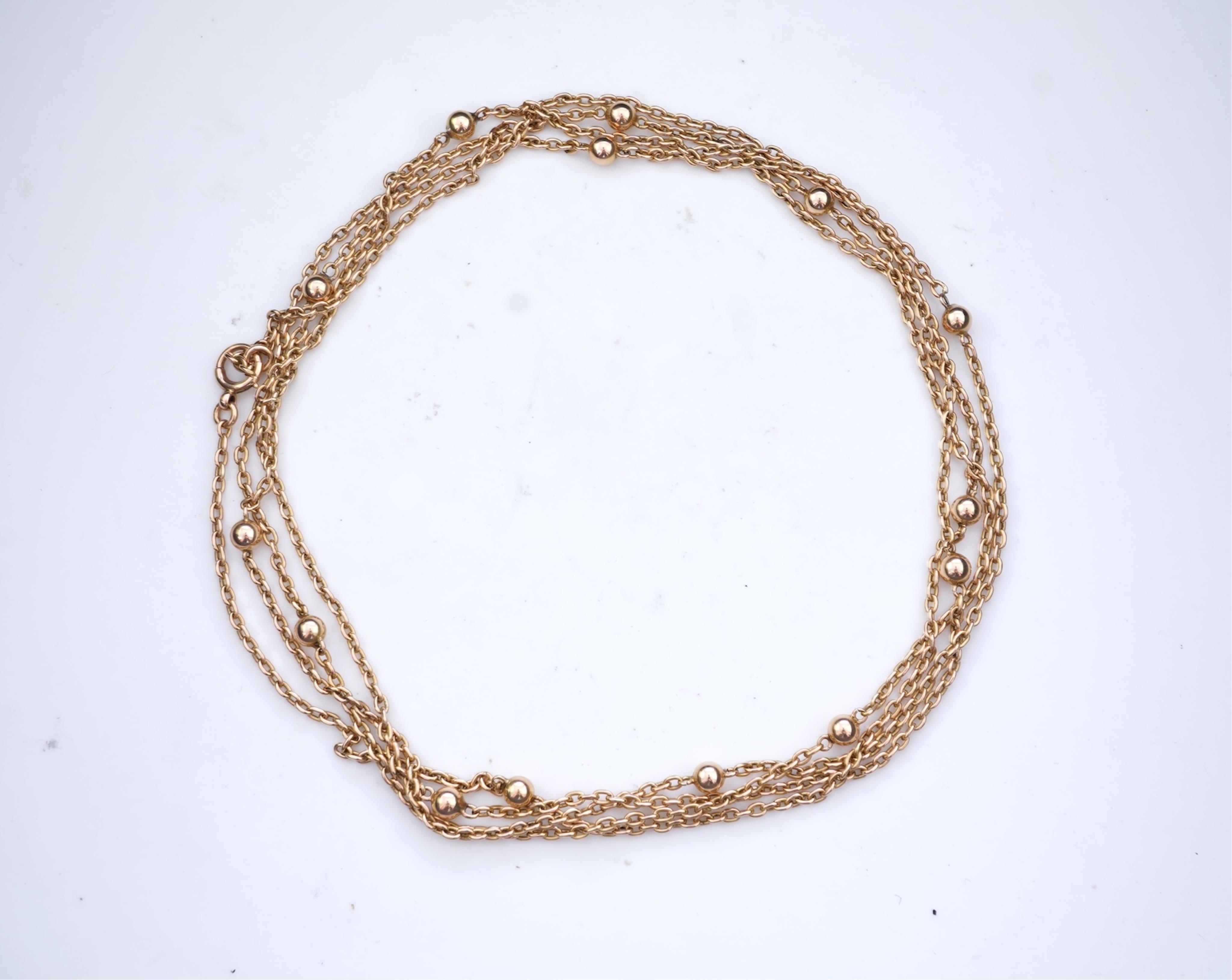 A gold long guard chain, early 20th century